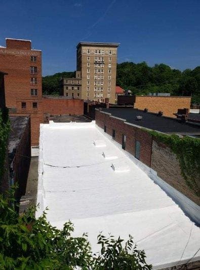 Roofing crew at work on a commercial roofing project by Genesee Valley Roofing